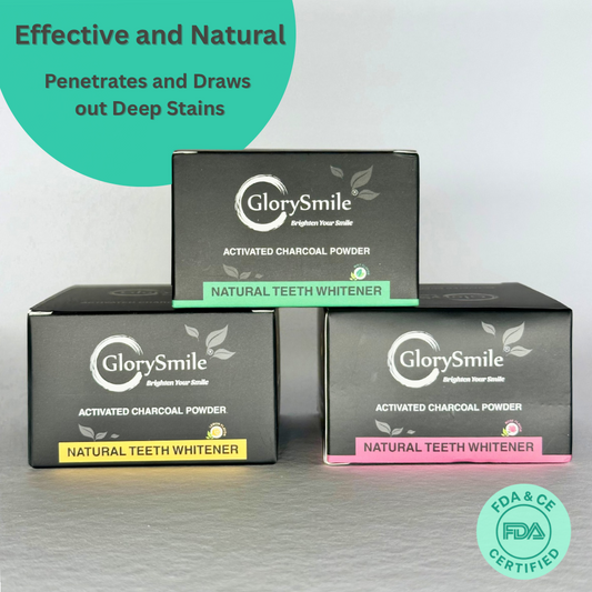 front view of Three boxes of Glory Smile activated charcoal powder with promotional text on a gray background